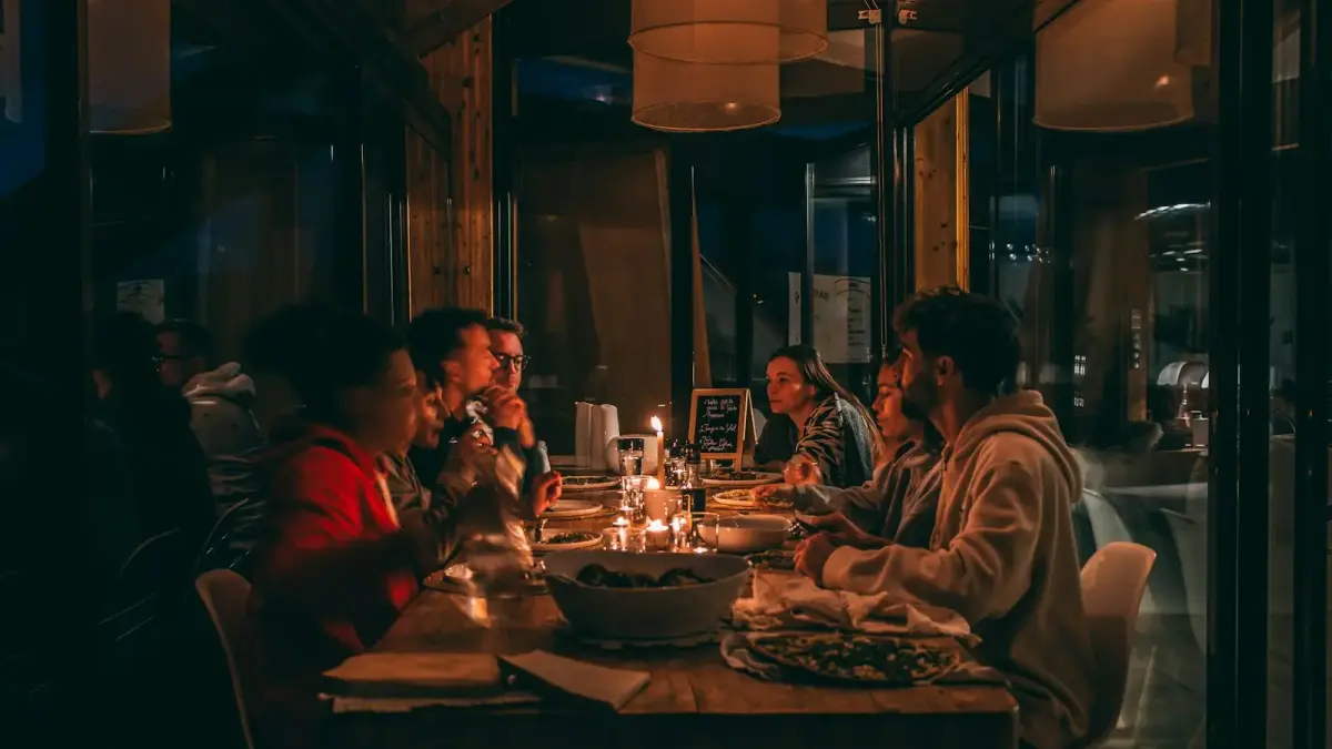 People enjoying a candlelit dinner at a dimly lit restaurant