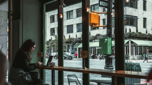 Woman sitting alone in morning kitchen light