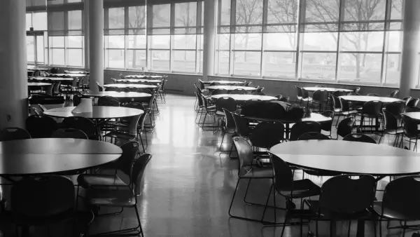 Empty cafeteria with round tables and chairs