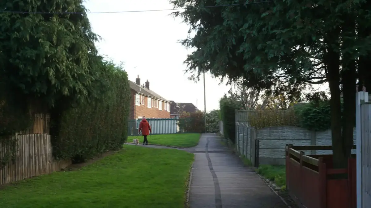 A person in a red coat walks on a path