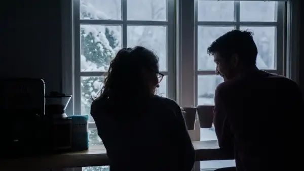 silhouette of man and woman sitting on bar stools