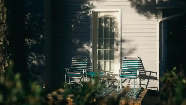 Two old friends sitting on porch chairs in the golden evening light