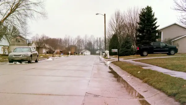gray Chevrolet sedan parked near empty road