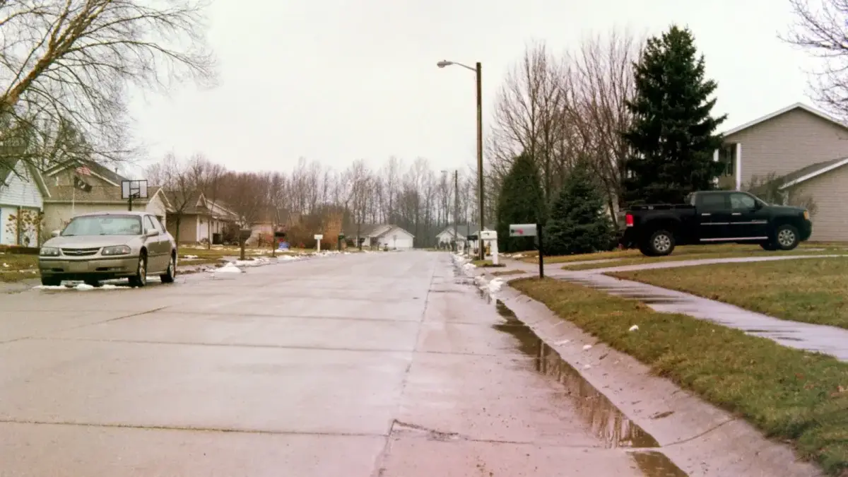 gray Chevrolet sedan parked near empty road