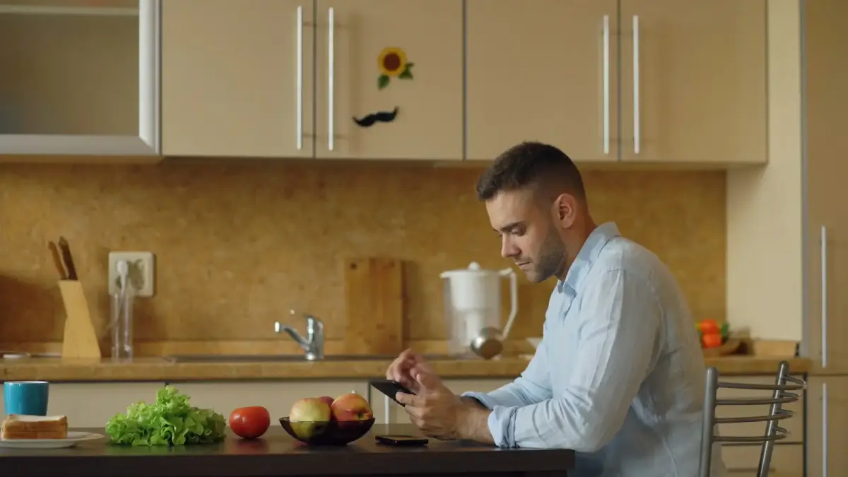 a person adjusting the thermostat in a quiet home