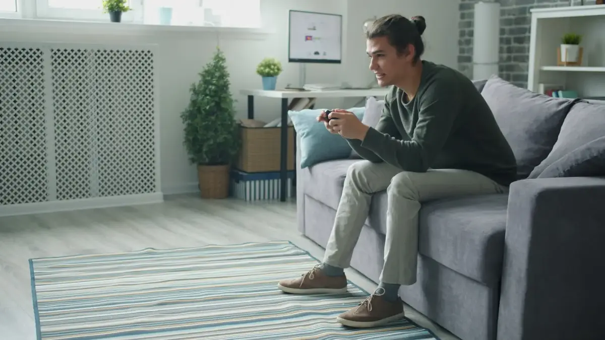 Man playing video games on couch