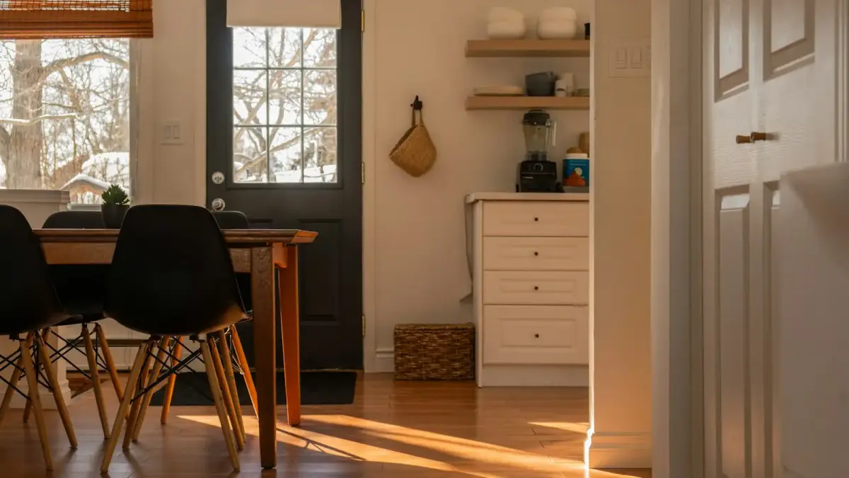 Sunlight streams into a cozy dining area and kitchen