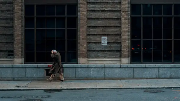 person standing beside building during daytime
