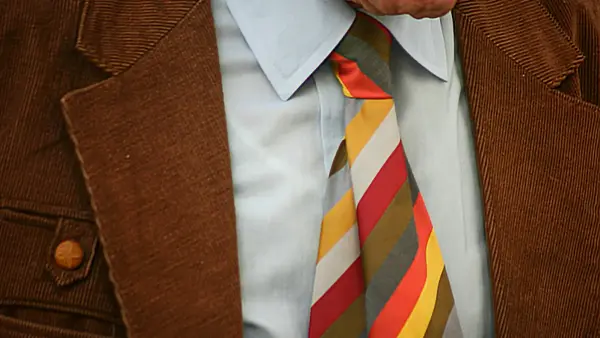 man in brown suit jacket