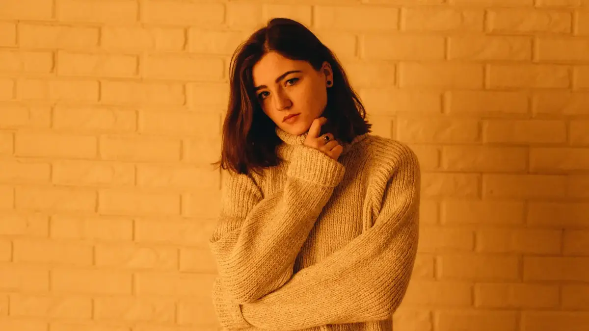 Person with arms crossed in contemplative posture