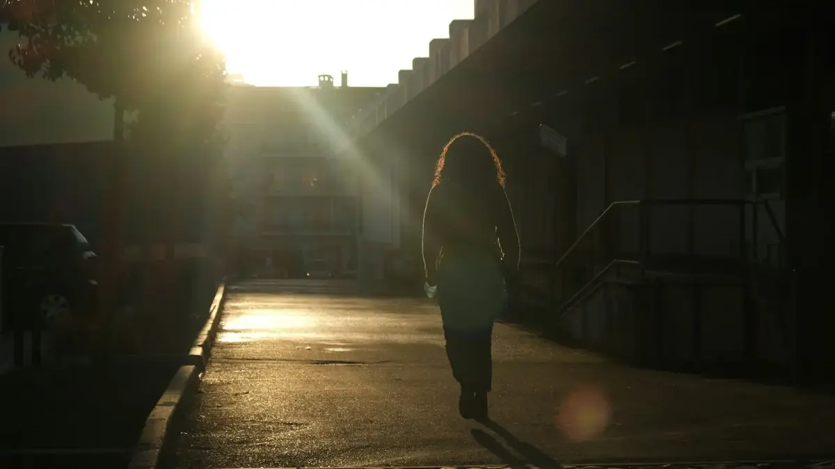 man in black jacket walking on street during daytime