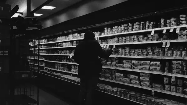 Person shopping in a grocery store aisle