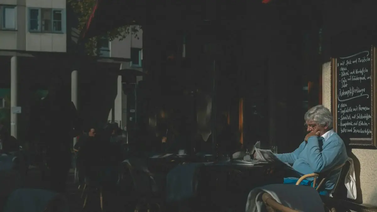 man in white dress shirt sitting on chair