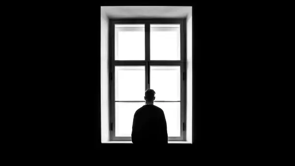 man standing in front of the window