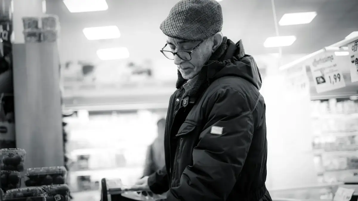 man in black jacket and knit cap