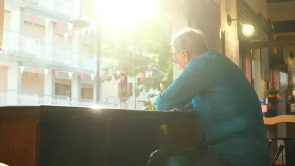A woman with silver hair in warm sunlight, confident and peaceful in her own skin